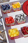 Fruits in colorful cardboard bowls