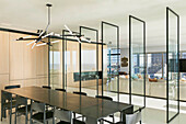 Raumteiler aus Glas zwischen Essbereich und Lounge in einem Luxus-Penthouse