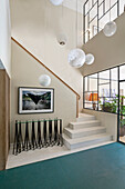 Bright, spacious stairwell with beige walls