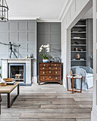 Classic living room in gray with coffered wall and passageway