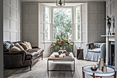 Classic living room in gray with coffered walls and bay window