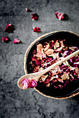 Dried rose petals in a bowl