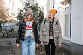 Two women in autumn clothes taking a walk