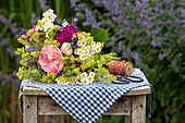 Rustic summer bouquet of roses, lady's mantle, feverfew, lavender and carnations