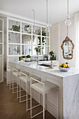 Kitchen counter with marble top and bar stool