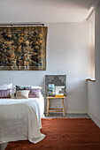 Tapestry above queen size bed in bedroom