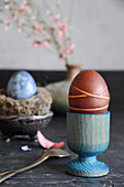 Easter egg dyed with beets in an egg cup