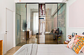 Wardrobe, doors with transparent and reflective effect, in a bedroom