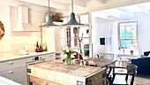 Old butcher's block as a kitchen island, above it pendant lights
