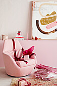Pink upholstered chair and wrapped Christmas presents
