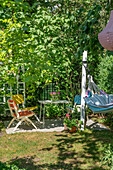 Gemütlicher Sitzplatz im Schatten auf der Terrasse im Sommergarten