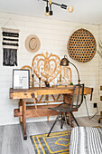 Old carpenter's bench as desk and boho accessories in the study