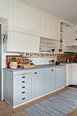 Bright country-house kitchen with white and light grey cupboards