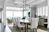 Elegant dining room with wooden table and upholstered chairs
