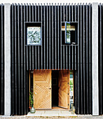 Black façade with wooden doors