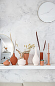 Vases painted with homemade chalk paint on wall-mounted shelf