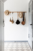 Hallway with coat rack on white wall