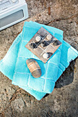 Noughts and crosses game pieces on turquoise towels