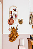 Shelves, hat, mirror and clothes hooks in child's bedroom