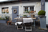 Terrace area with fireplace, wooden furniture and autumnal decorations