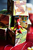 Figure of Father Christmas on stacked vintage playing cubes