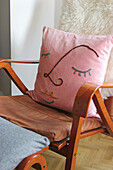 DIY cushion cover with line art on armchair
