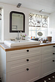 Bathroom with generous bureau as a vanity with an integrated sink