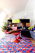 Farbenfrohes Wohnzimmer mit Weihnachtsbaum und Interieur im Retrostil