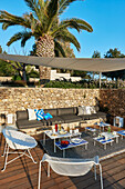 Set table, blue and white side tables and seating on terrace