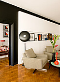 Photo lamp, swivel armchair and coffee table in the living room in 60s style