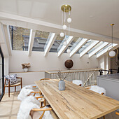 Dining area in open-plan interior with skylights