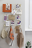 DIY memo board with photos, kitchen towels and bag