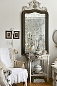 Old foxed mirror and vintage-style decorations in living room