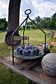 Wreath of globe thistles with little crown on cake stand