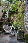 Small sitting area on the terrace, stairs leading to the garden
