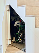 Storage space with bicycle under the stairs