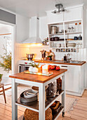 Small kitchen with white furnishings and wooden accents