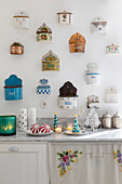 Collection of different salt containers on a white kitchen wall