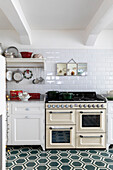 Country-style kitchen with metro tiles and patterned floor