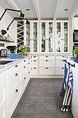 White fitted kitchen cabinets with glass cabinet and wine rack
