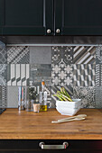 Wooden kitchen counter top, with grey patterned tiled backsplash