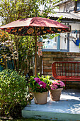 Flower pots, garden bench, and a patio umbrella on terrace