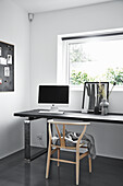 Designer chair with a desk in a monochrome study