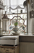 French atmosphere with old soup tureen on windowsill in the kitchen