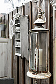 Vintage lantern in front of wooden fence on the terrace