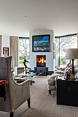 Living room with fireplace and classic furniture and large windows