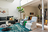 Bright living room with green accent carpet and fig tree