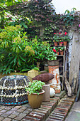 Vintage style garden decorations with baskets, flower pots, and fish sculpture