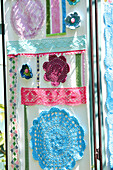 Screen decorated with doilies, trims and crochet flowers