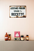 Vintage decoration with enamel sign and old apothecary bottles